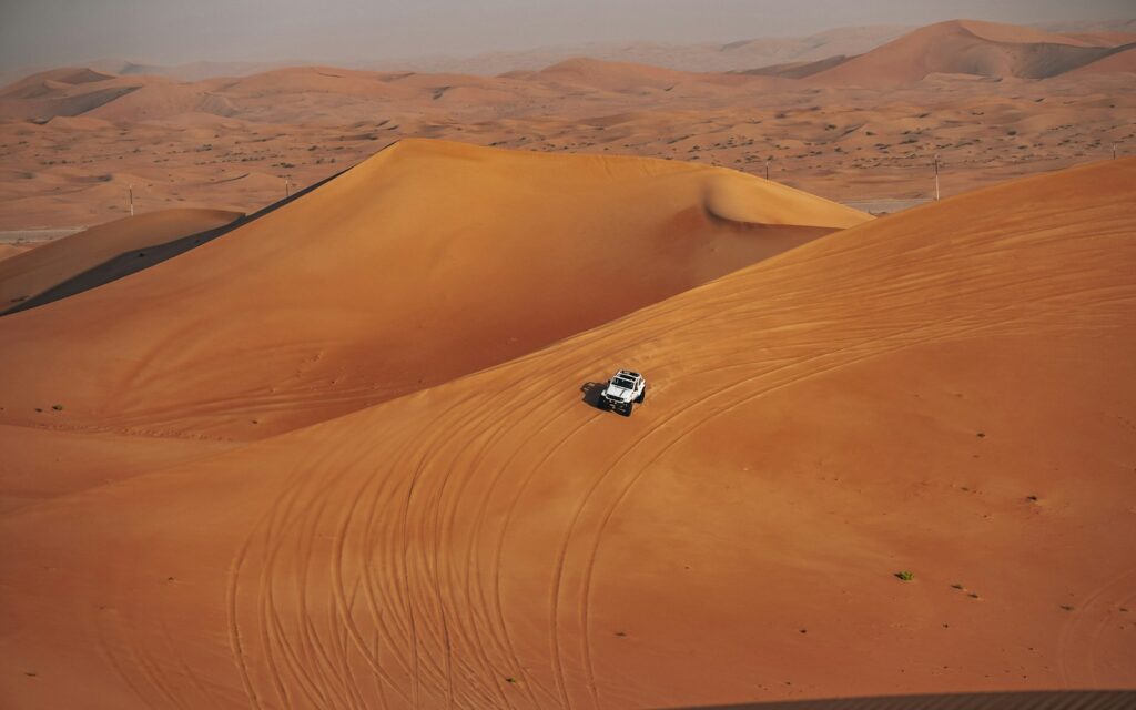 Premium 4x4 desert safari vehicle in the dunes