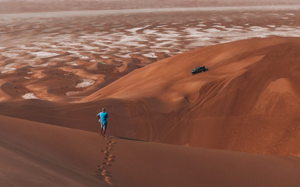 Traveler walking on a high desert dune
